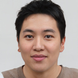 Joyful asian young-adult male with short  brown hair and brown eyes