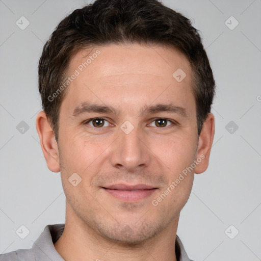 Joyful white young-adult male with short  brown hair and brown eyes