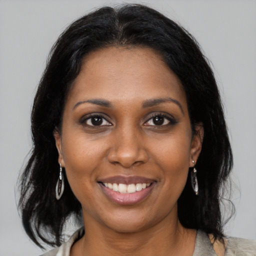 Joyful black young-adult female with medium  black hair and brown eyes