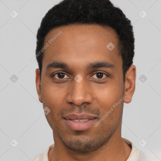 Joyful black young-adult male with short  black hair and brown eyes