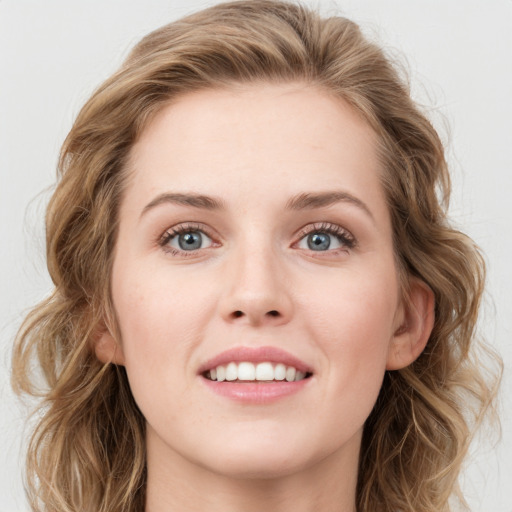 Joyful white young-adult female with medium  brown hair and blue eyes