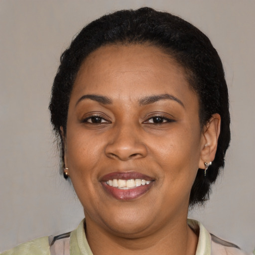 Joyful latino adult female with medium  black hair and brown eyes
