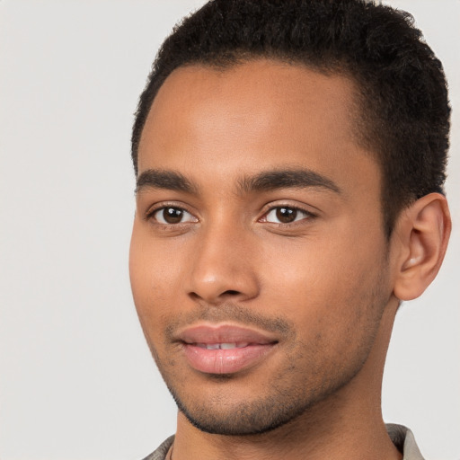 Joyful black young-adult male with short  brown hair and brown eyes