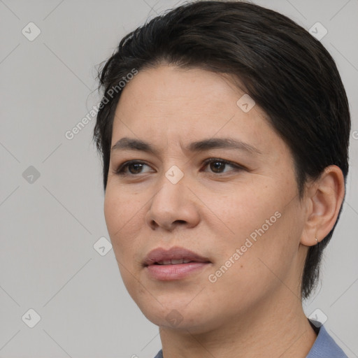 Joyful white adult female with medium  black hair and brown eyes