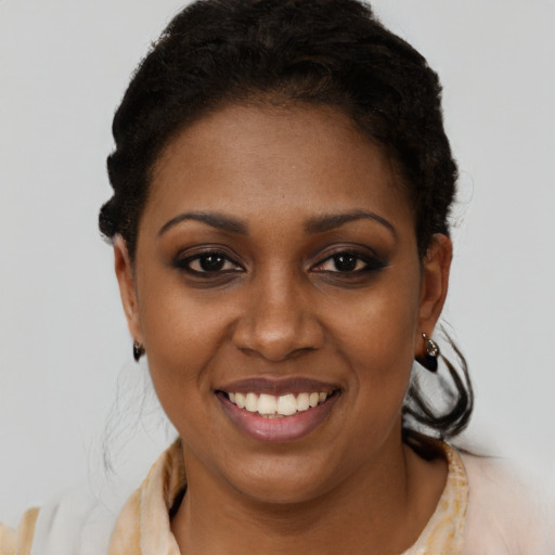Joyful black young-adult female with short  brown hair and brown eyes