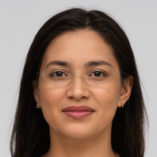 Joyful latino young-adult female with long  brown hair and brown eyes