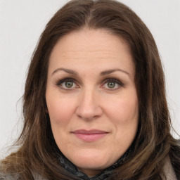 Joyful white adult female with long  brown hair and brown eyes