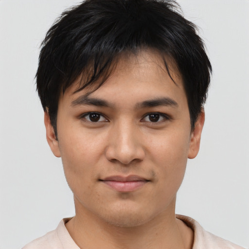Joyful asian young-adult male with short  black hair and brown eyes