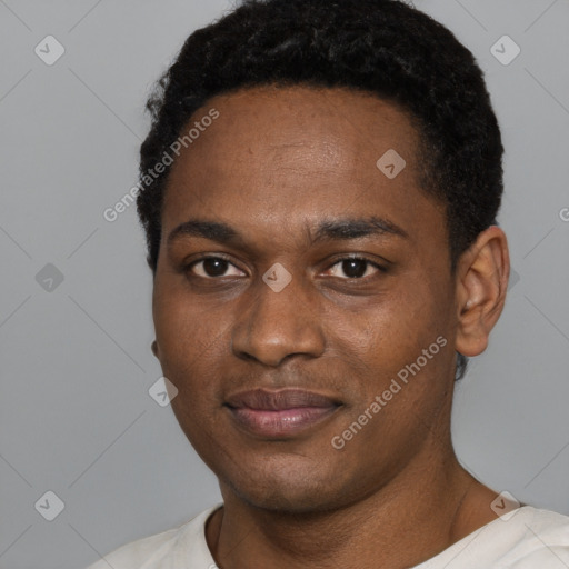 Joyful black young-adult male with short  black hair and brown eyes