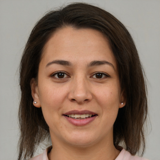 Joyful white young-adult female with medium  brown hair and brown eyes