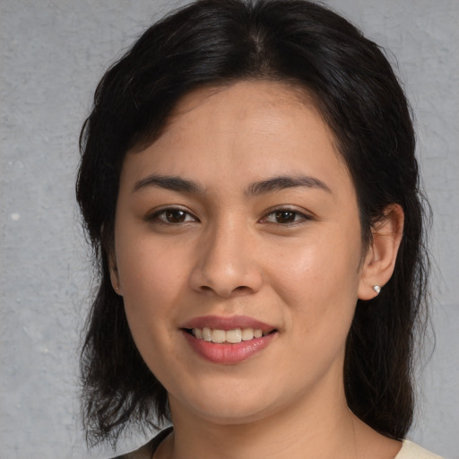 Joyful asian young-adult female with medium  brown hair and brown eyes