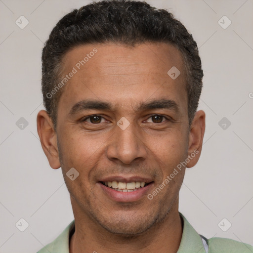 Joyful latino young-adult male with short  brown hair and brown eyes