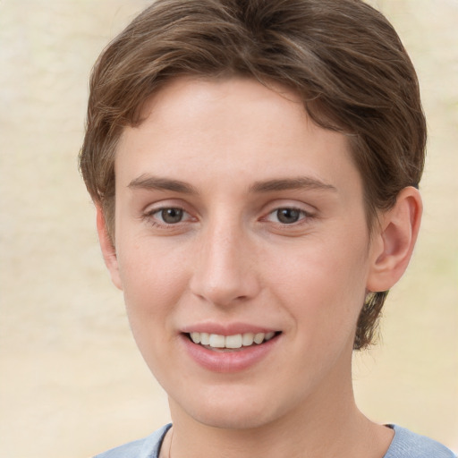 Joyful white young-adult female with short  brown hair and grey eyes