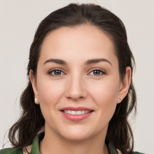 Joyful white young-adult female with long  brown hair and grey eyes