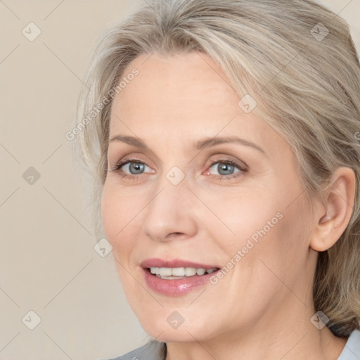 Joyful white adult female with medium  brown hair and grey eyes