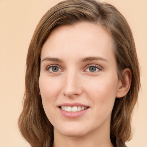 Joyful white young-adult female with long  brown hair and green eyes