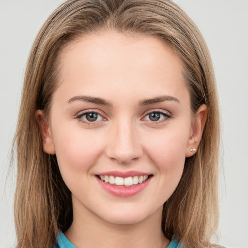 Joyful white young-adult female with long  brown hair and grey eyes