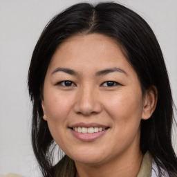 Joyful asian young-adult female with medium  brown hair and brown eyes