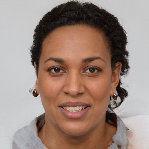 Joyful latino adult female with short  brown hair and brown eyes