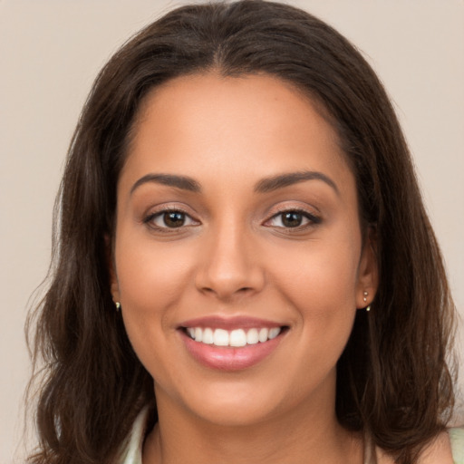 Joyful white young-adult female with long  brown hair and brown eyes