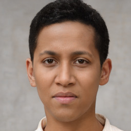 Joyful latino young-adult male with short  brown hair and brown eyes