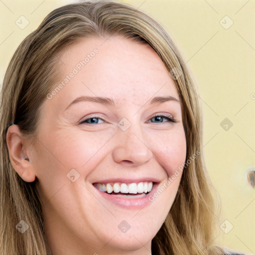 Joyful white young-adult female with long  brown hair and blue eyes