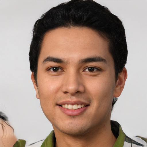 Joyful white young-adult male with short  black hair and brown eyes