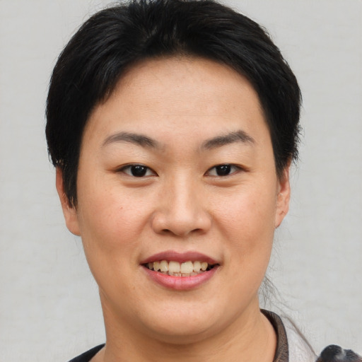 Joyful white young-adult female with short  black hair and brown eyes