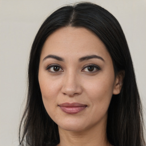 Joyful asian young-adult female with long  brown hair and brown eyes