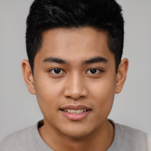 Joyful asian young-adult male with short  black hair and brown eyes