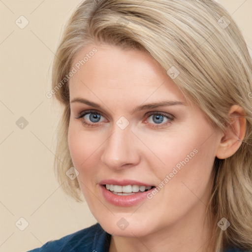 Joyful white young-adult female with long  brown hair and blue eyes