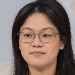 Joyful white adult female with long  brown hair and brown eyes