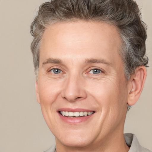 Joyful white adult male with short  brown hair and grey eyes