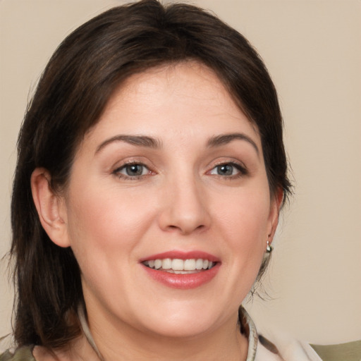 Joyful white young-adult female with medium  brown hair and brown eyes