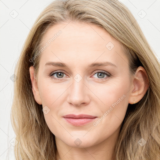 Joyful white young-adult female with long  brown hair and blue eyes