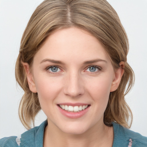 Joyful white young-adult female with medium  brown hair and blue eyes