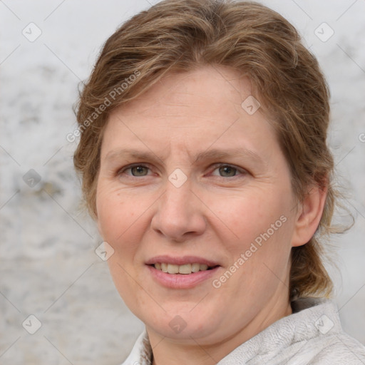 Joyful white adult female with medium  brown hair and blue eyes