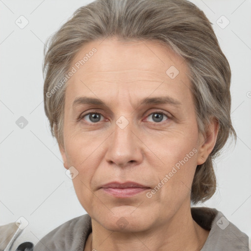 Joyful white adult female with medium  brown hair and grey eyes