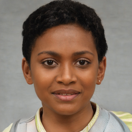 Joyful black child female with short  black hair and brown eyes