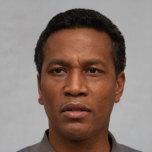 Neutral latino adult male with short  black hair and brown eyes