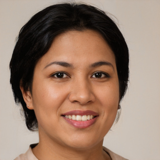 Joyful latino young-adult female with medium  brown hair and brown eyes