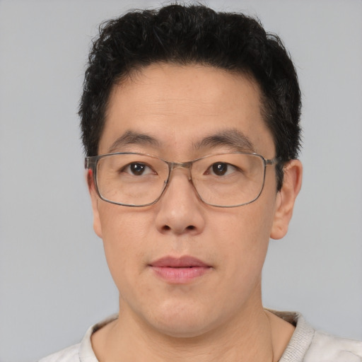 Neutral asian adult male with short  brown hair and brown eyes
