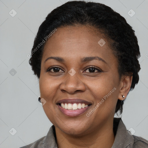 Joyful black adult female with short  black hair and brown eyes