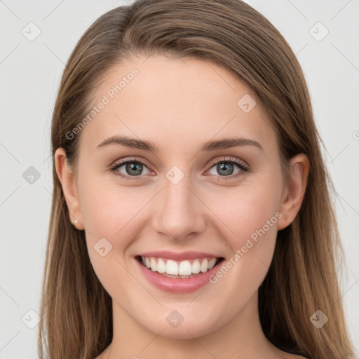 Joyful white young-adult female with long  brown hair and grey eyes