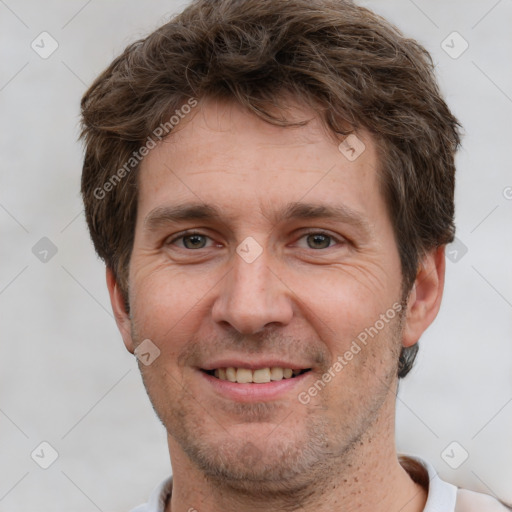 Joyful white adult male with short  brown hair and grey eyes