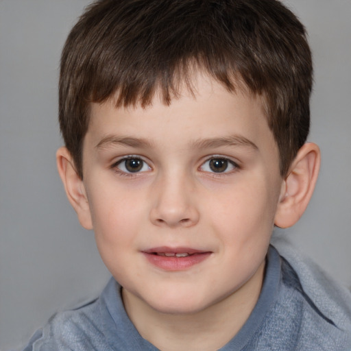 Joyful white child male with short  brown hair and brown eyes