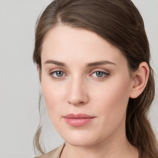 Joyful white young-adult female with long  brown hair and grey eyes