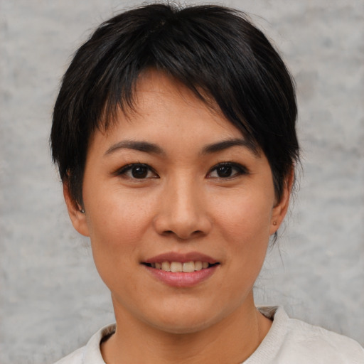 Joyful asian young-adult female with short  black hair and brown eyes