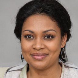 Joyful black young-adult female with medium  brown hair and brown eyes