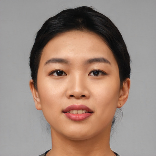 Joyful asian young-adult female with short  black hair and brown eyes